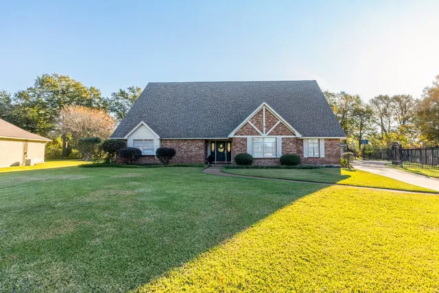 a front view of house with yard and green space