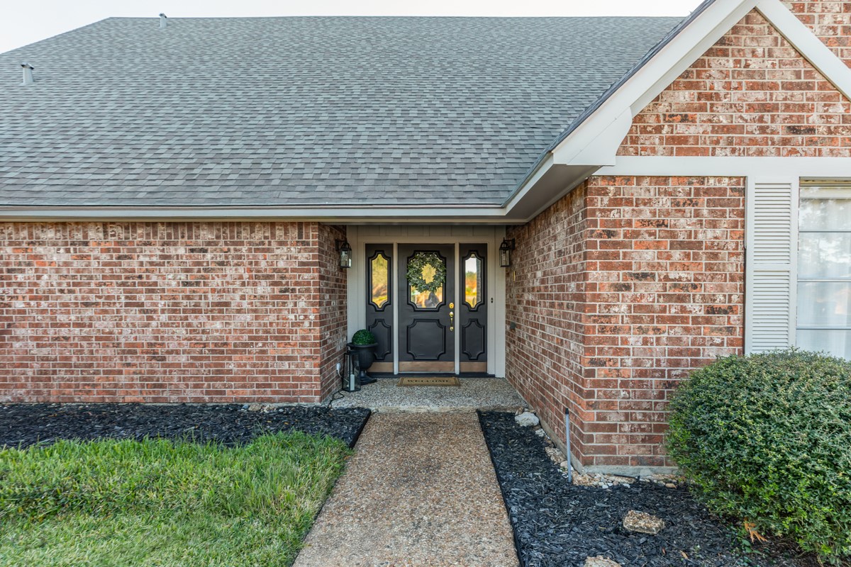 1210 Nottingham Lane Beaumont, TX 77706 - Photo 2 of 50 front view of a brick house with a yard