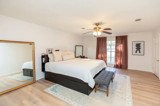 a bedroom with a bed and a chandelier