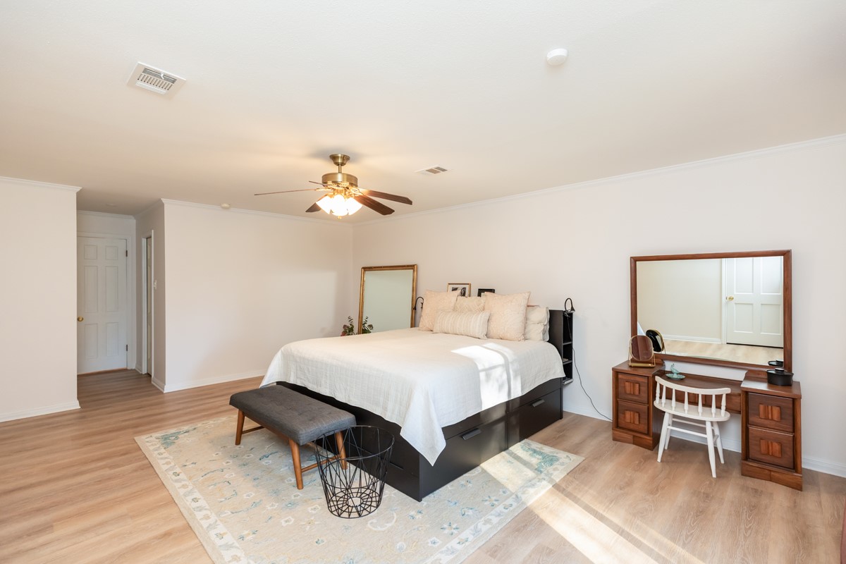 1210 Nottingham Lane Beaumont, TX 77706 - Photo 25 of 50 a bedroom with a bed and a chandelier