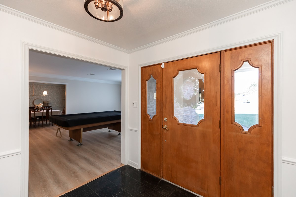 1210 Nottingham Lane Beaumont, TX 77706 - Photo 3 of 50 a view of a hallway with wooden floor and glass door