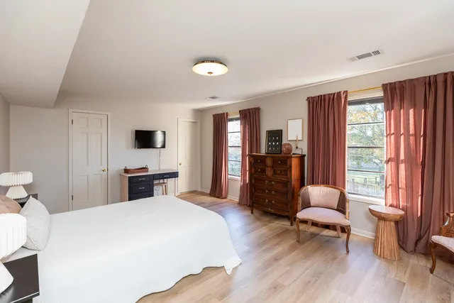 a bedroom with a bed and a chair