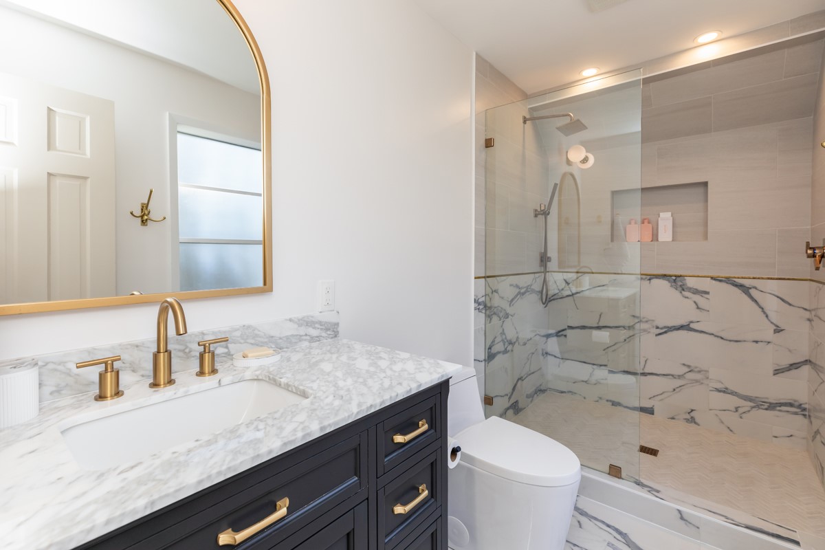 1210 Nottingham Lane Beaumont, TX 77706 - Photo 35 of 50 a bathroom with a granite countertop sink a toilet and a mirror