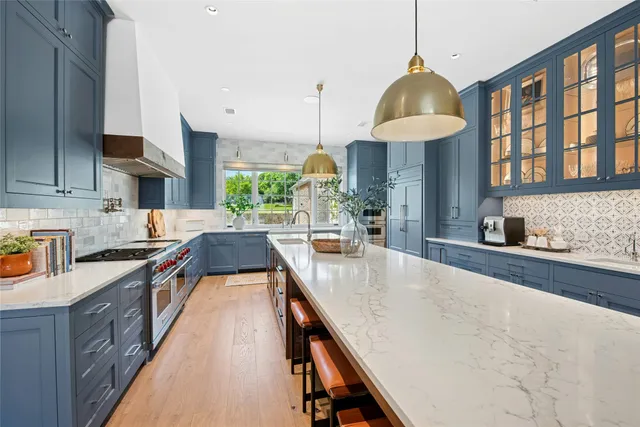 a kitchen with stainless steel appliances granite countertop a stove and cabinets