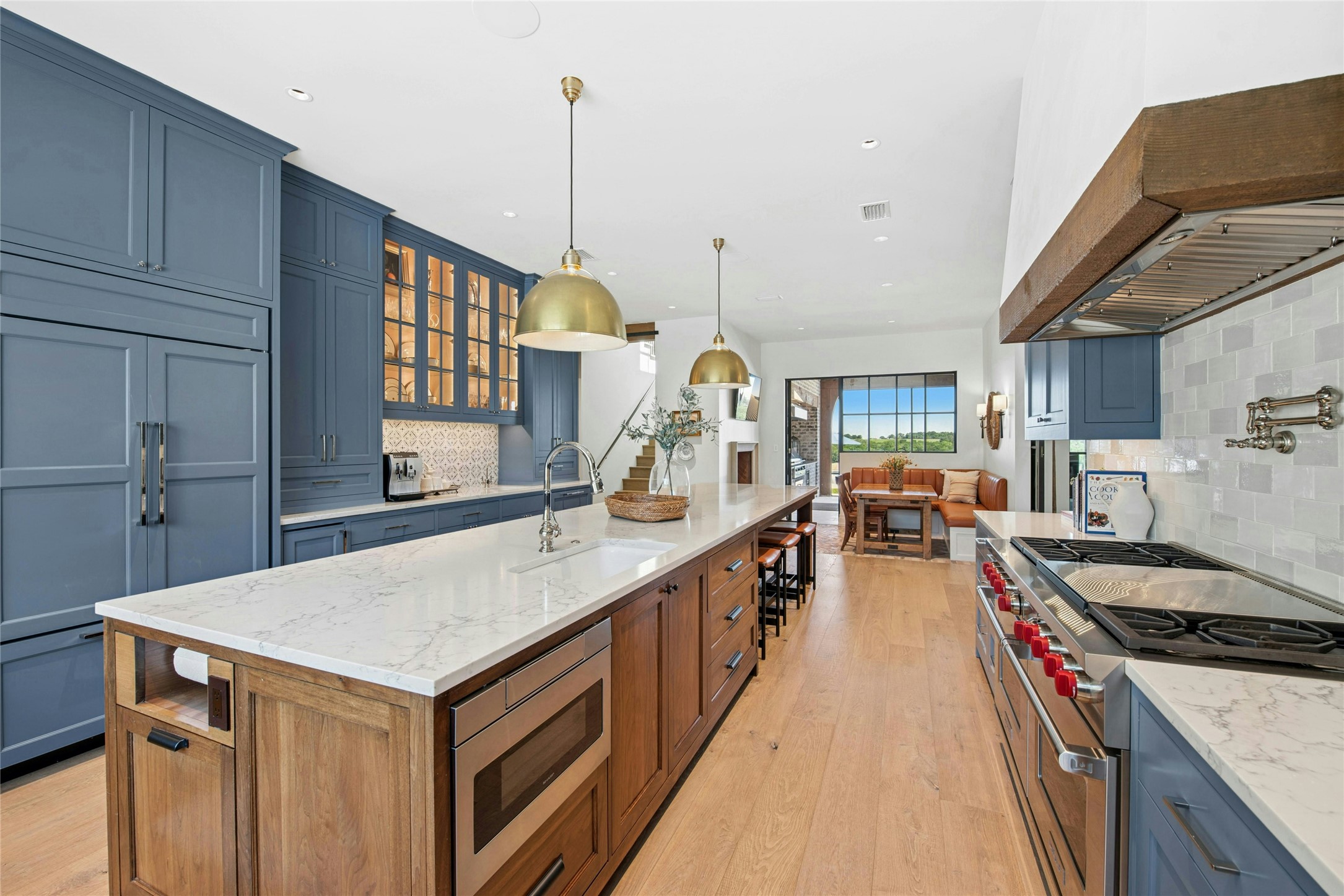 658 Fordtran Road New Ulm, TX 78950 - Photo 12 of 50 a kitchen with stainless steel appliances granite countertop a sink a stove and a wooden floors