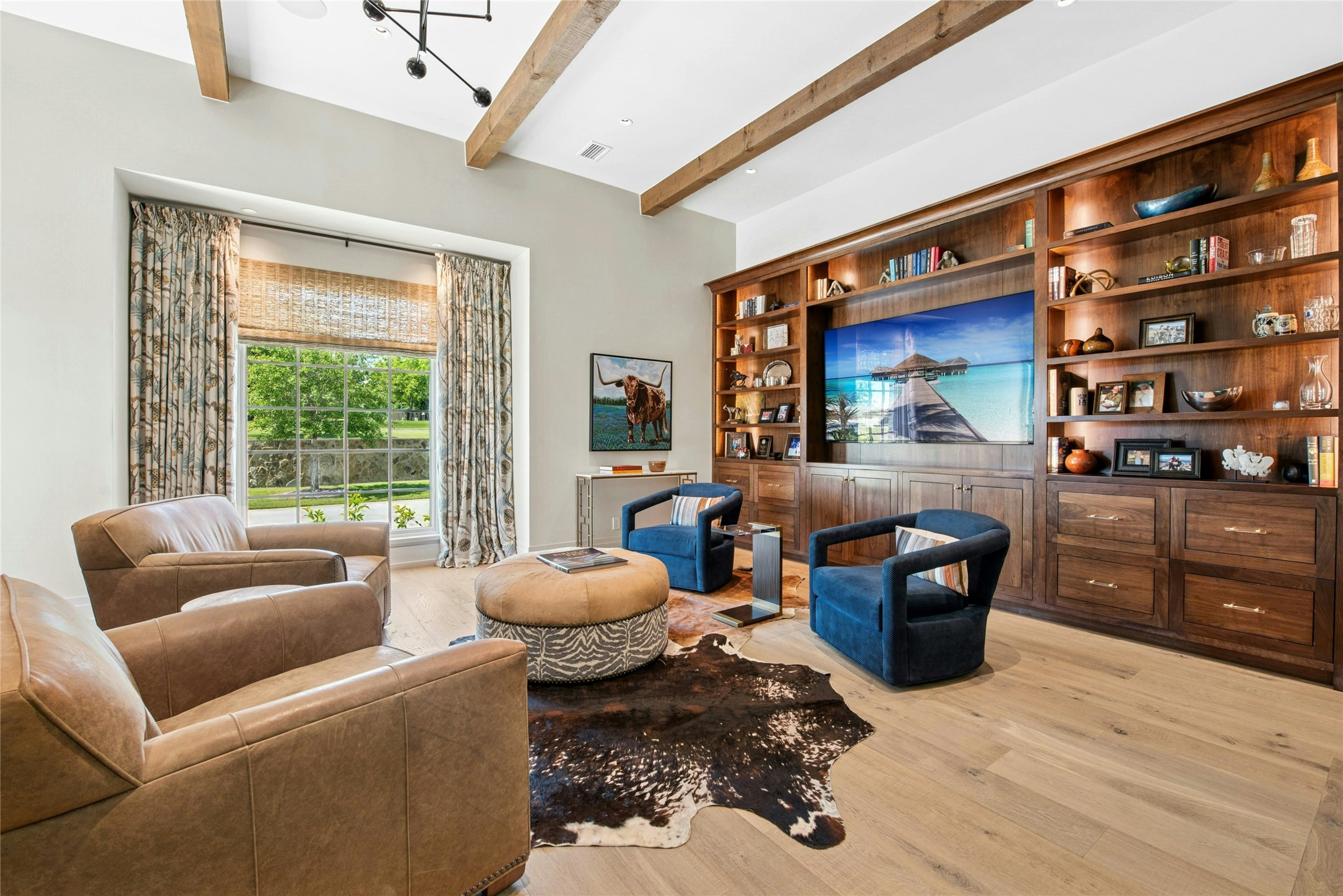658 Fordtran Road New Ulm, TX 78950 - Photo 14 of 50 a living room with furniture a flat screen tv and a floor to ceiling window