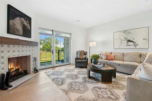 a living room with furniture a window and a fireplace