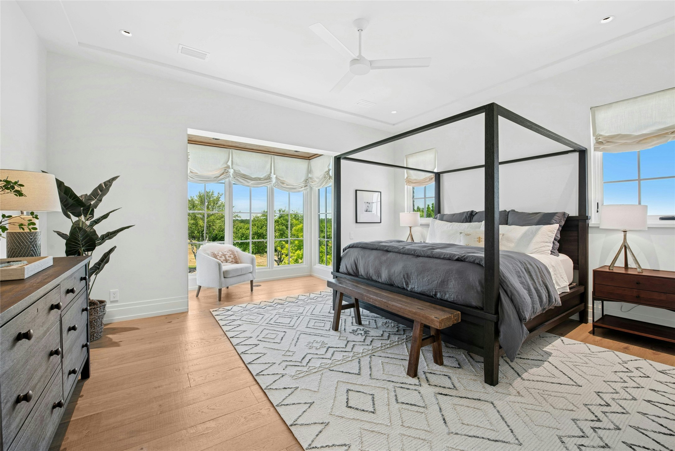 658 Fordtran Road New Ulm, TX 78950 - Photo 21 of 50 a bedroom with a bed a lamp and a large window with the garden view