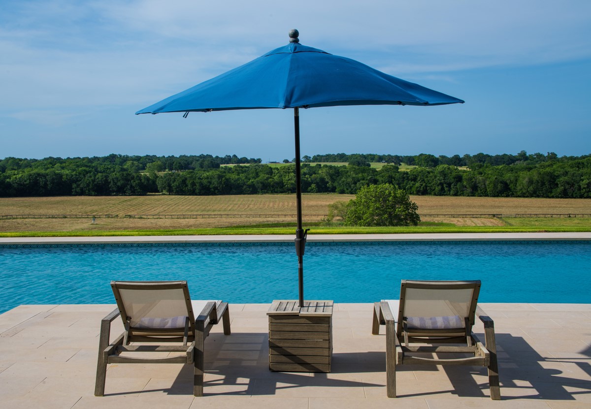 658 Fordtran Road New Ulm, TX 78950 - Photo 35 of 50 a view of table and chair under an umbrella
