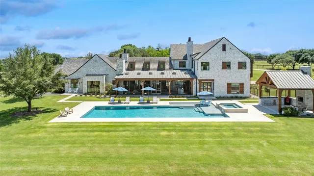 a view of a house with swimming pool and porch