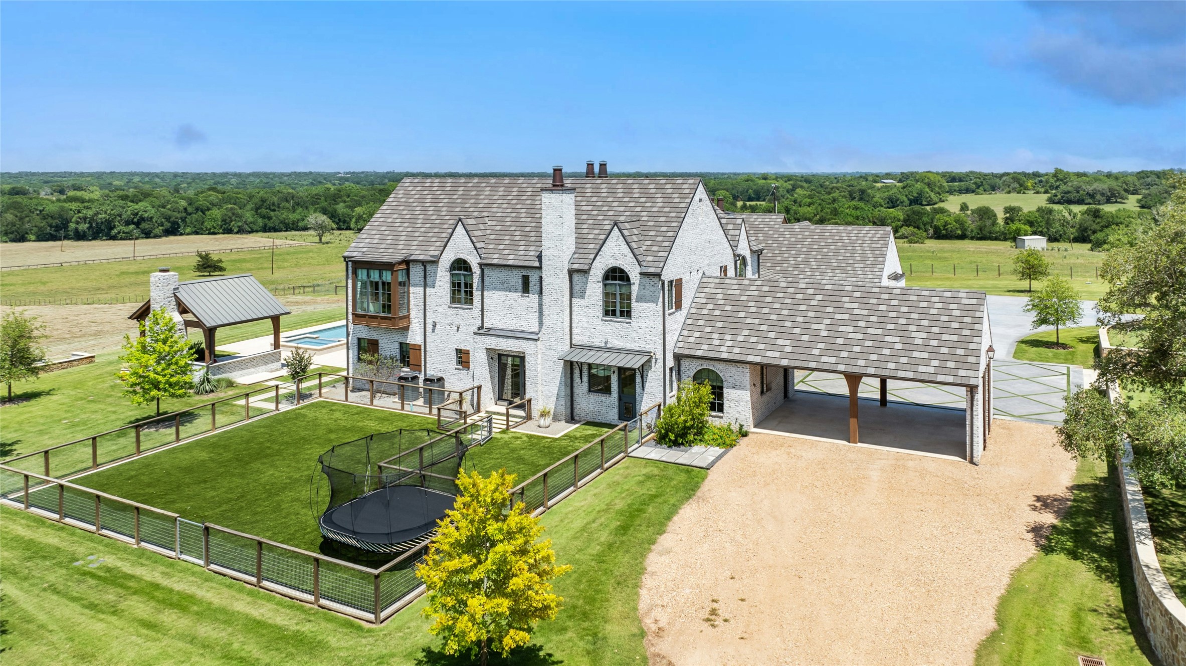 658 Fordtran Road New Ulm, TX 78950 - Photo 49 of 50 an aerial view of a house with swimming pool garden and mountain view
