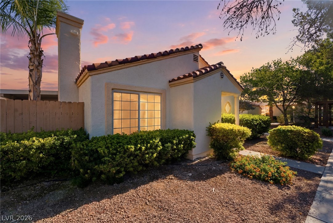 5449 Bugle Way, Unit 104 Las Vegas, NV 89108 - Photo 1 of 33 This charming home features classic architecture and mature landscaping under a vibrant sky.