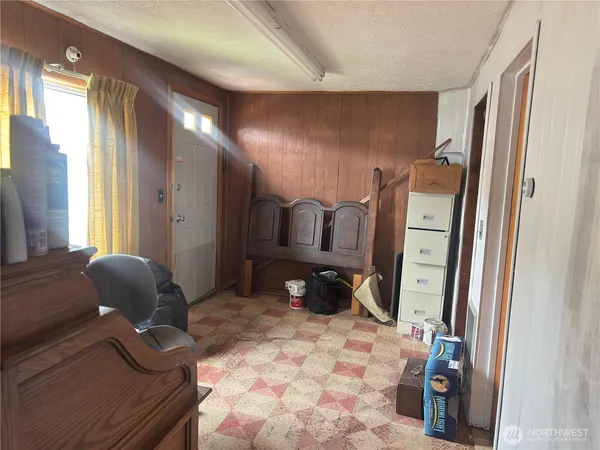 a bedroom with a bed and chair