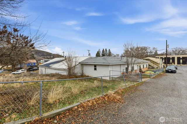 a view of a house with a yard and sitting area