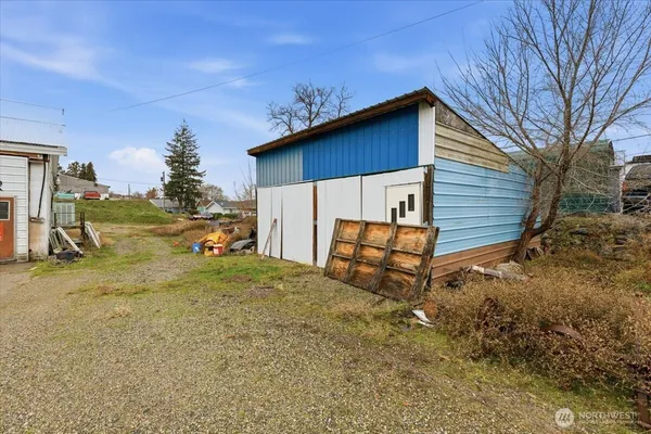 a view of backyard with wooden fence