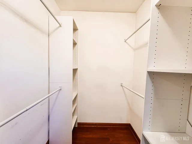 a view of walk in closet with clothes