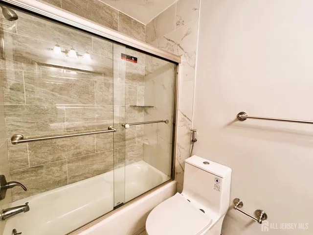 a bathroom with a shower and toilet