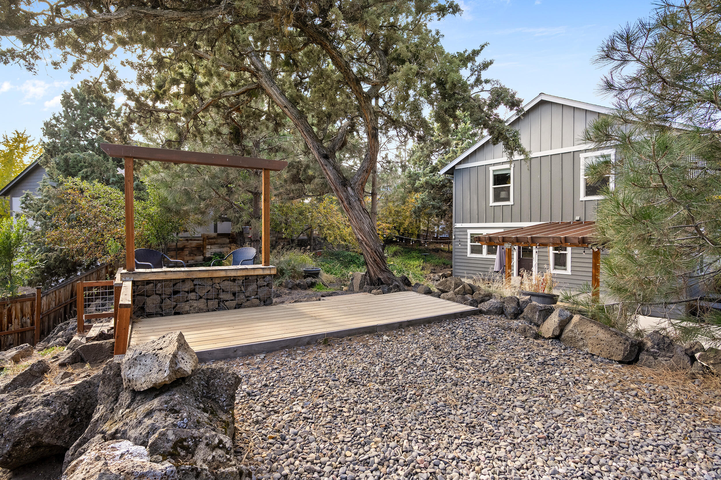 62906 Bilyeu Way Bend, OR 97701 - Photo 84 of 100 a view of a white house with a yard and outdoor seating