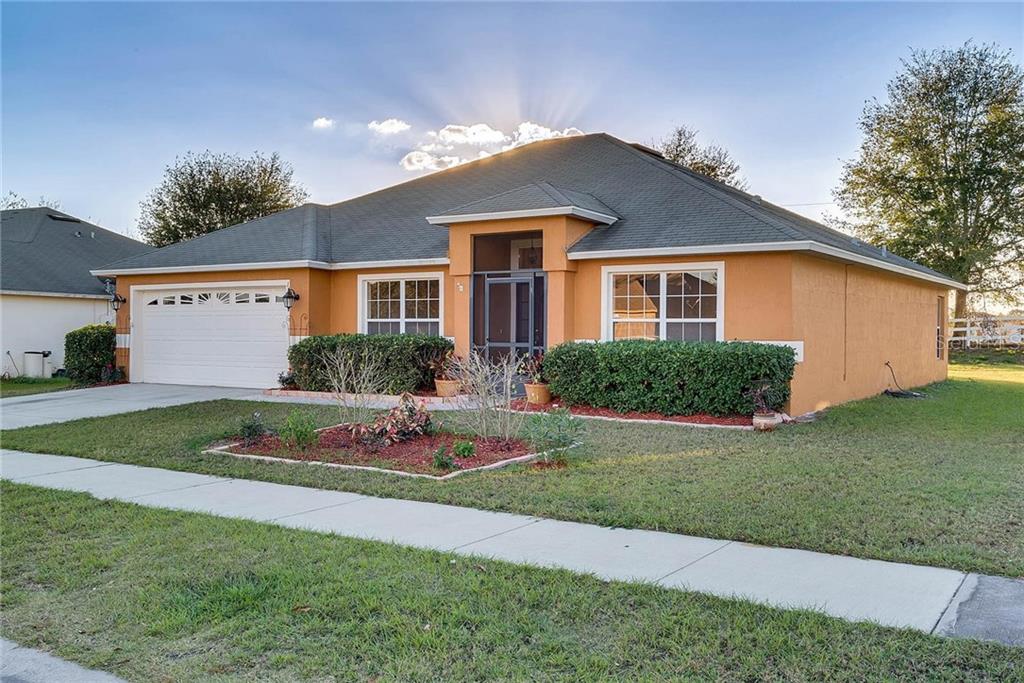 1127 Stratton Avenue Groveland, FL 34736 - Photo 1 of 1 a front view of a house with a garden