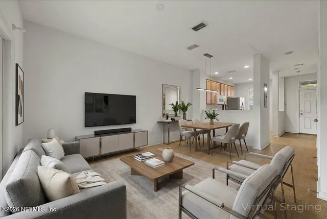 a bedroom with a bed a rug and painting on the wall