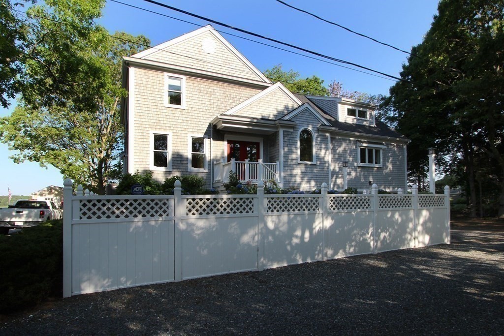 99 Monomoscoy Road West Mashpee, MA 02649 - Photo 11 of 40 a front view of a house with a yard