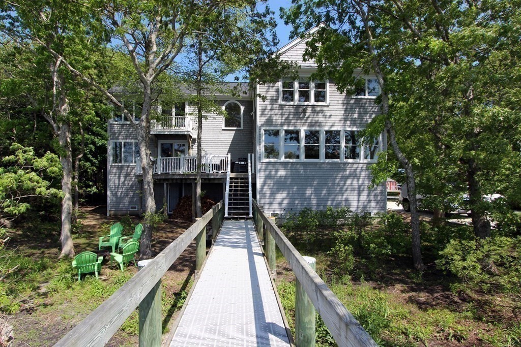 99 Monomoscoy Road West Mashpee, MA 02649 - Photo 14 of 40 a view of a house with wooden deck