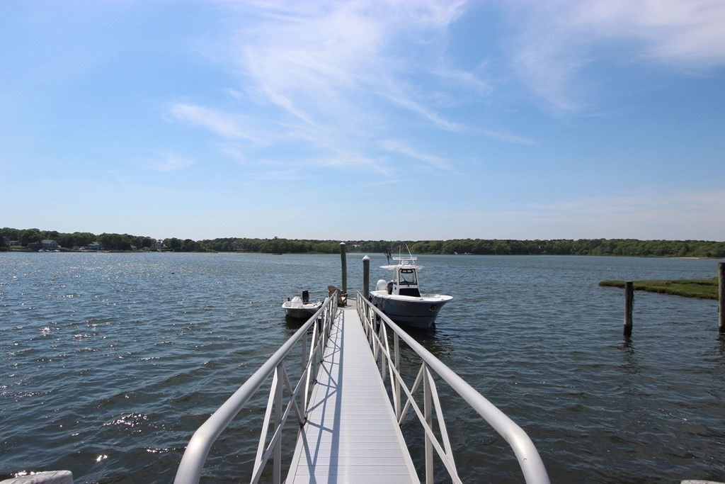 99 Monomoscoy Road West Mashpee, MA 02649 - Photo 16 of 40 a view of a lake with a large window