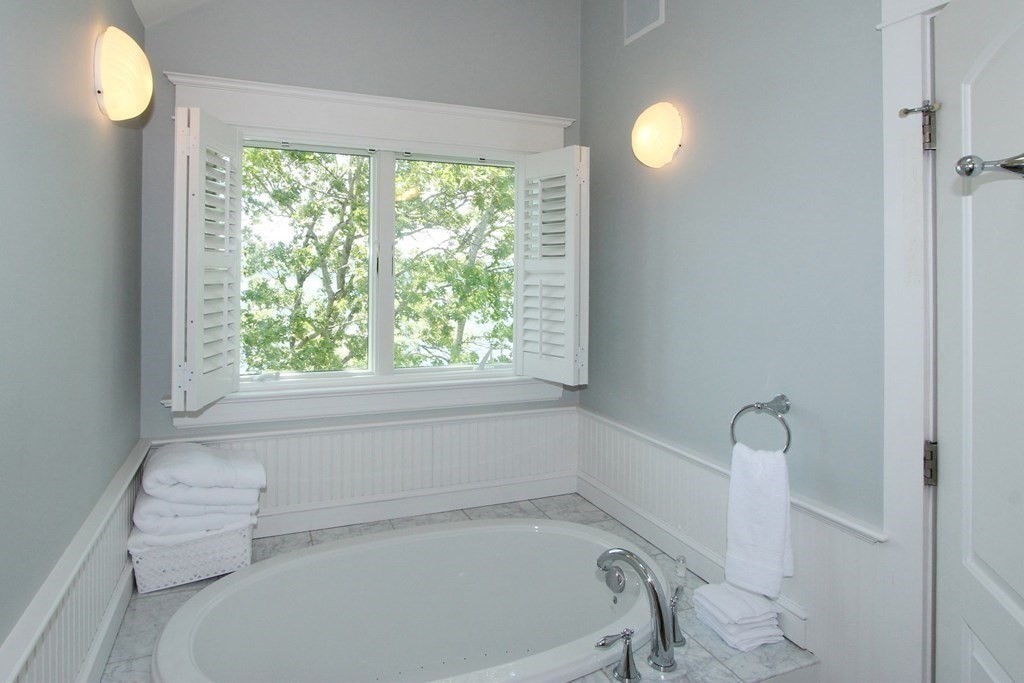 99 Monomoscoy Road West Mashpee, MA 02649 - Photo 20 of 40 a bathroom with a bathtub and a window