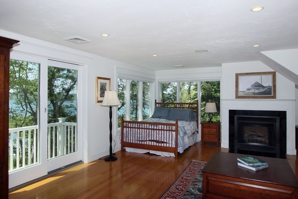 99 Monomoscoy Road West Mashpee, MA 02649 - Photo 23 of 40 a living room with furniture and a fireplace