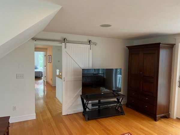 99 Monomoscoy Road West Mashpee, MA 02649 - Photo 24 of 40 a living room with furniture and a flat screen tv