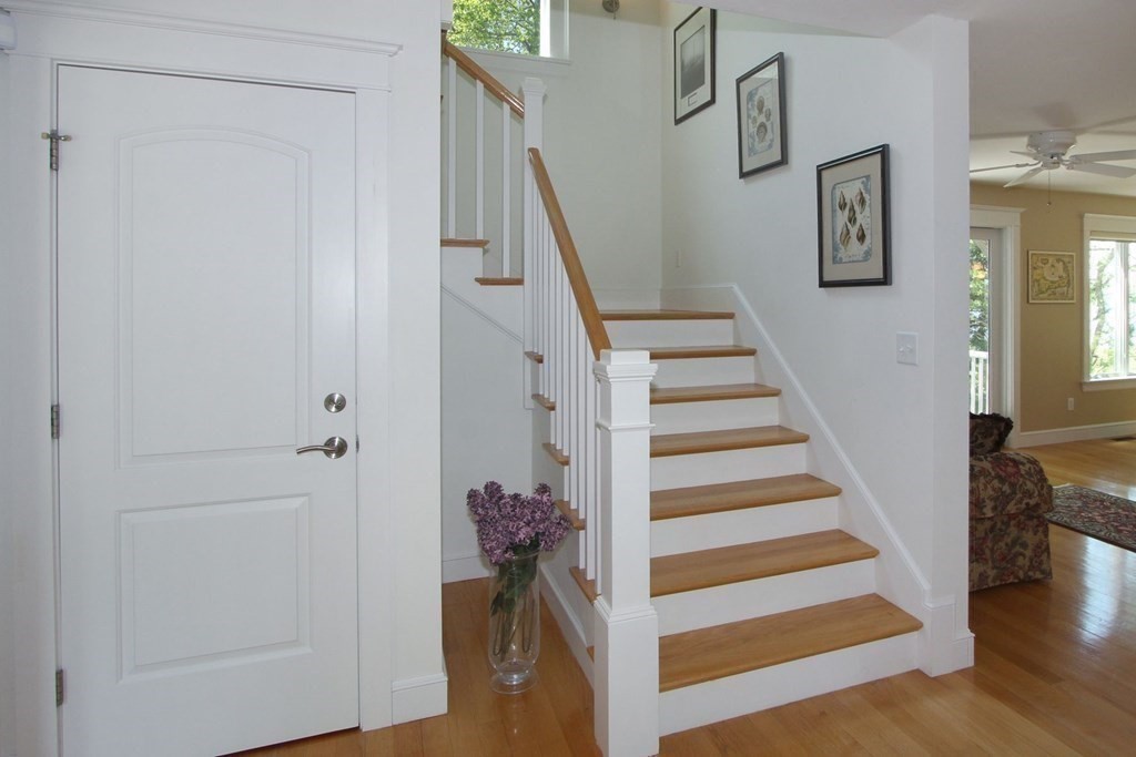 99 Monomoscoy Road West Mashpee, MA 02649 - Photo 25 of 40 a view of entryway with wooden floor and stairs