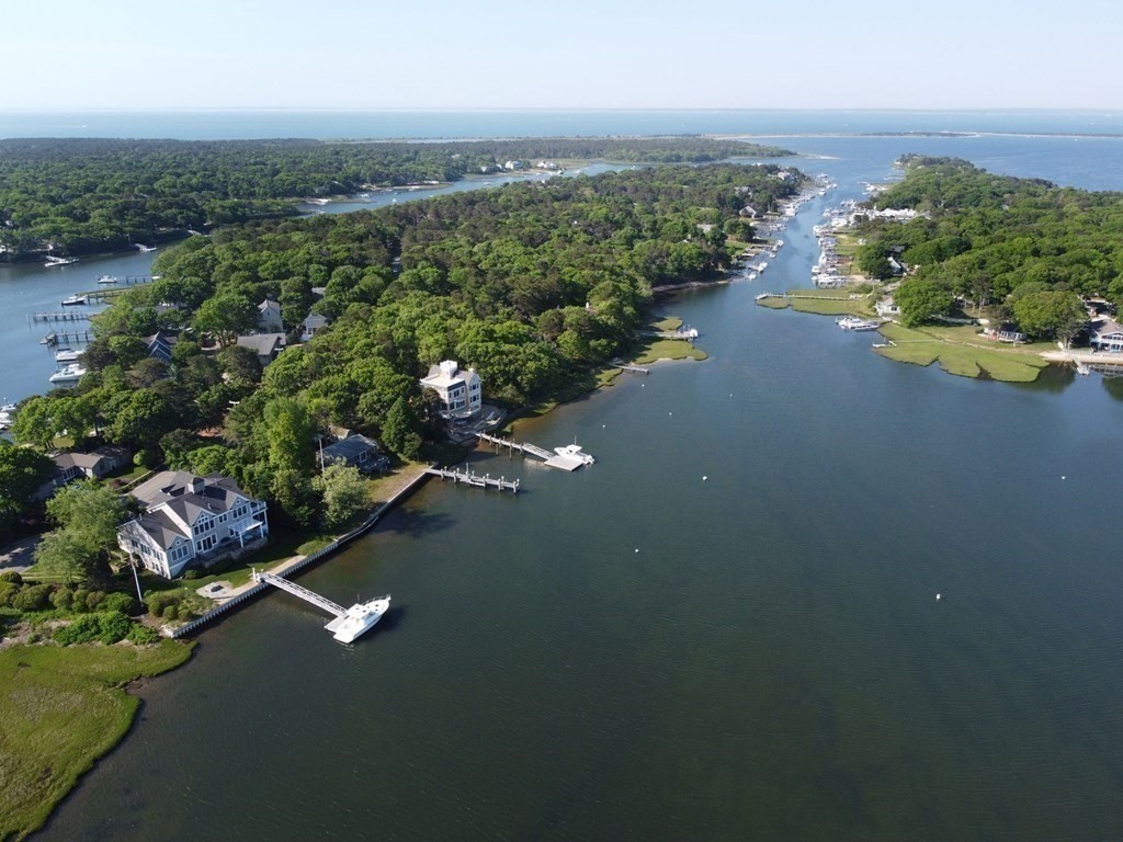 99 Monomoscoy Road West Mashpee, MA 02649 - Photo 4 of 40 an aerial view of a houses with ocean view