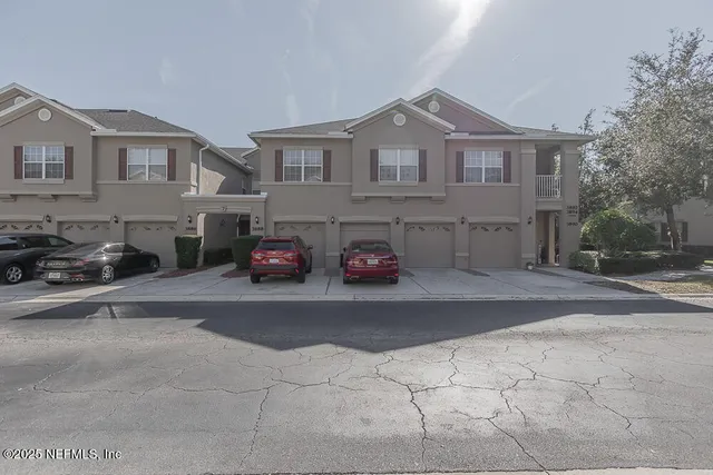 a car parked in front of a white house