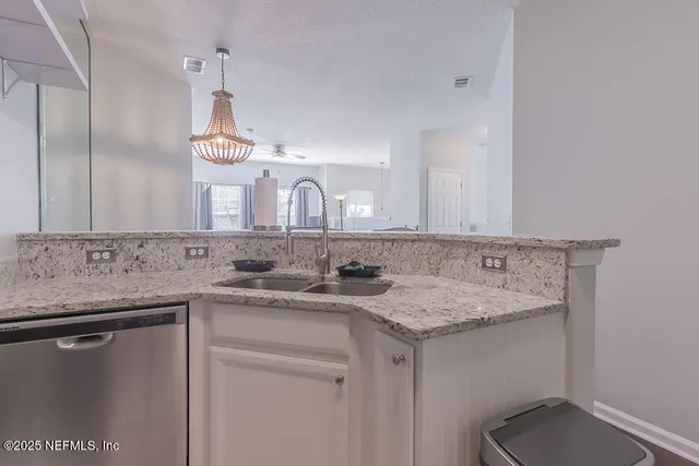 a bathroom with a granite countertop sink a mirror and vanity