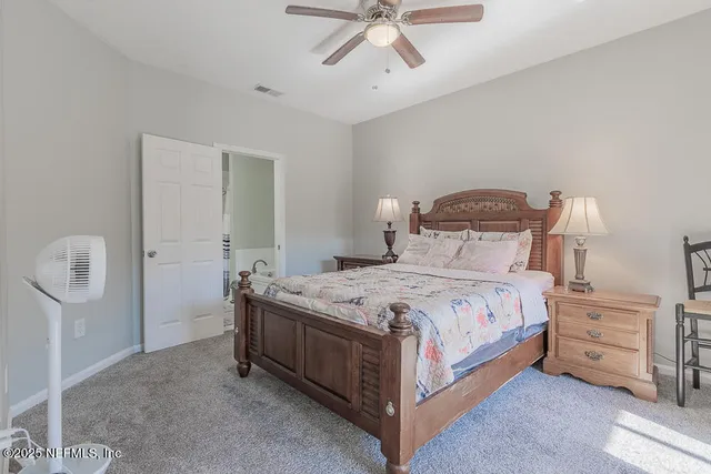 a bedroom with a bed and cabinets