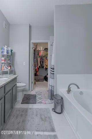 a bathroom with a tub sink and toilet