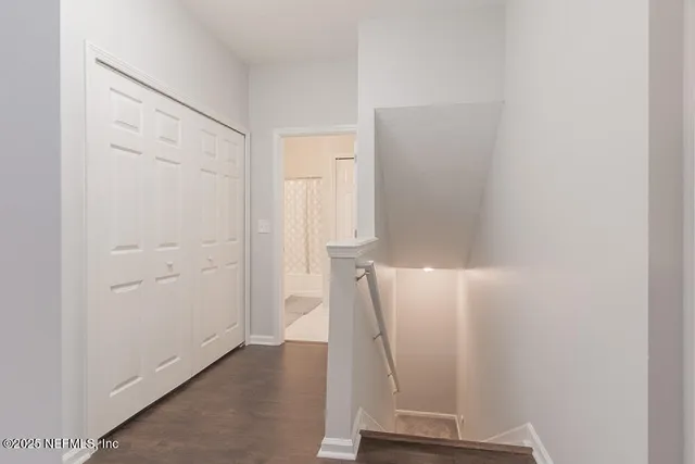 a bedroom with a bed tv and a window