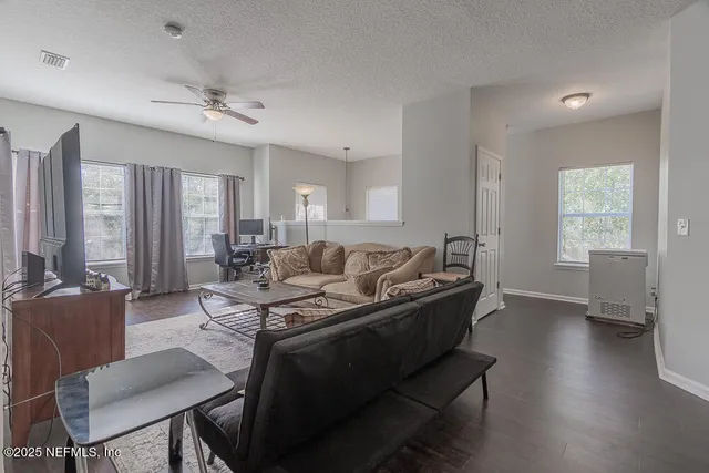 a living room with furniture window and wooden floor