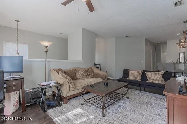 a living room with furniture and a lamp