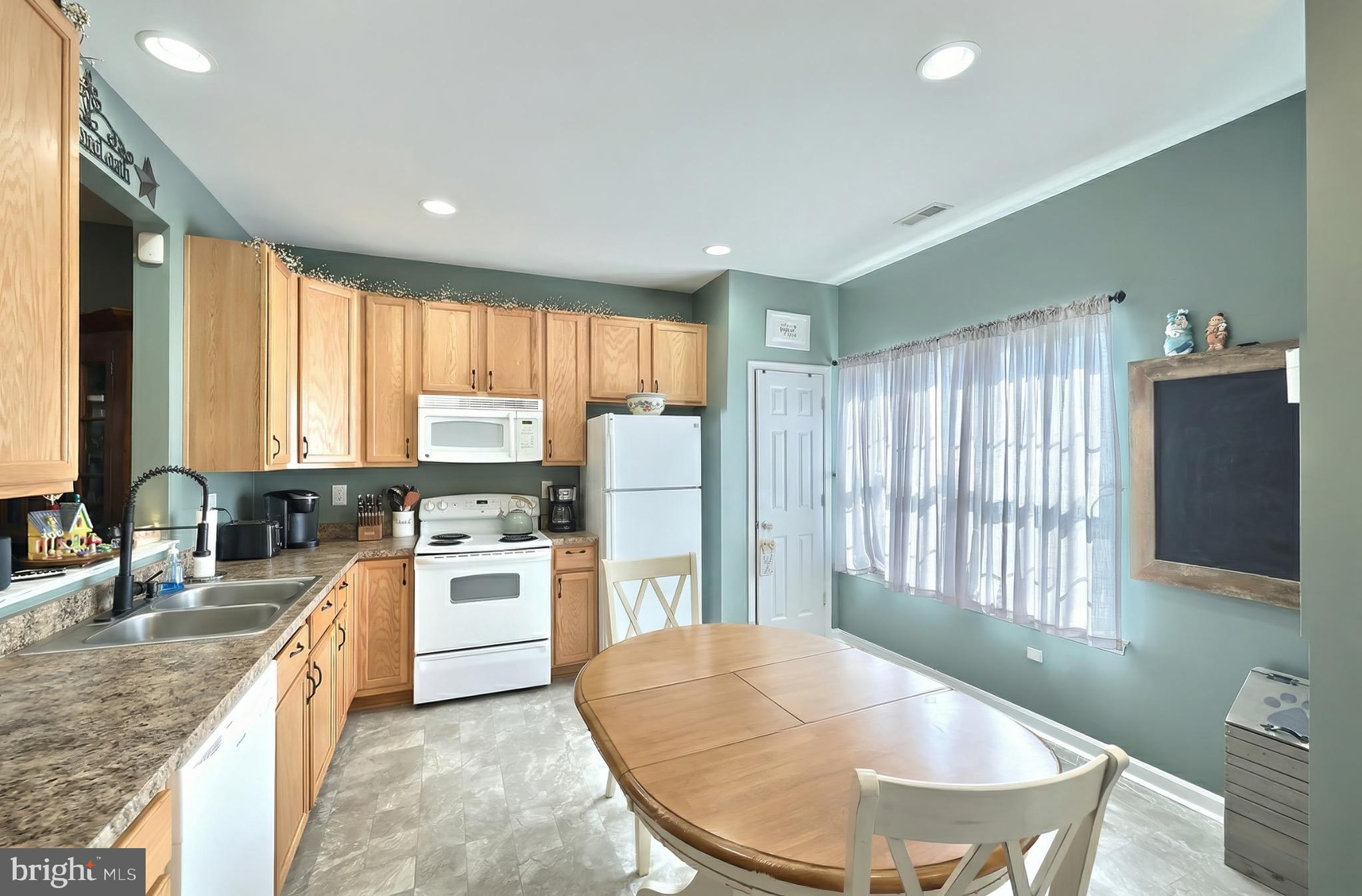 712 Spencer Drive Hanover, PA 17331 - Photo 9 of 23 a large kitchen with kitchen island a large window and cabinets