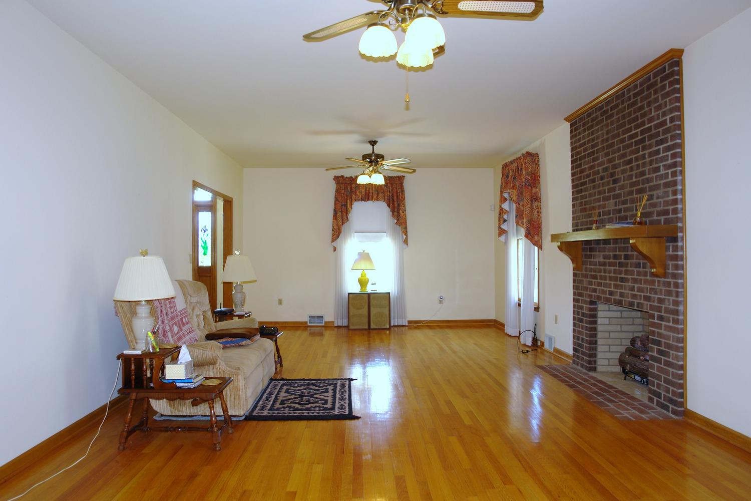 468 Liberty Road Penhook, VA 24137 - Photo 12 of 54 a living room with furniture and a chandelier