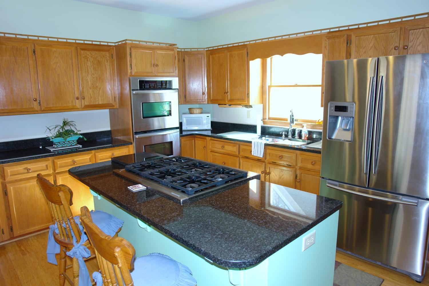 468 Liberty Road Penhook, VA 24137 - Photo 15 of 54 a kitchen with stainless steel appliances granite countertop a refrigerator a stove and a sink