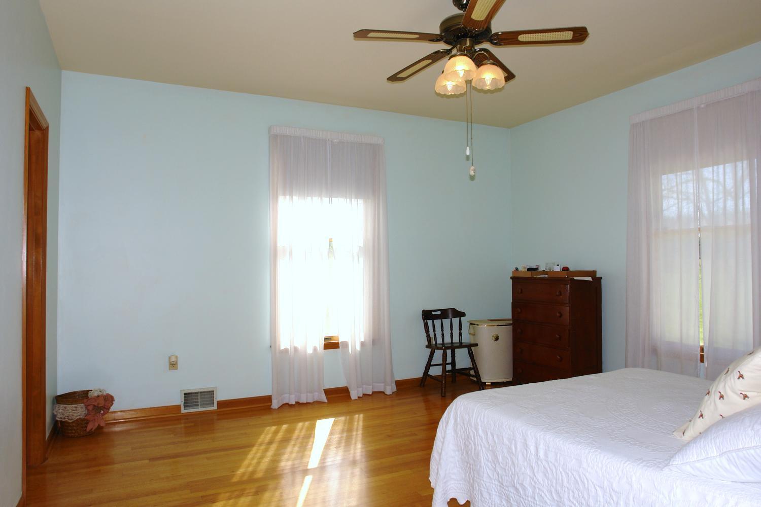 468 Liberty Road Penhook, VA 24137 - Photo 21 of 54 a bedroom with a bed and a chandelier
