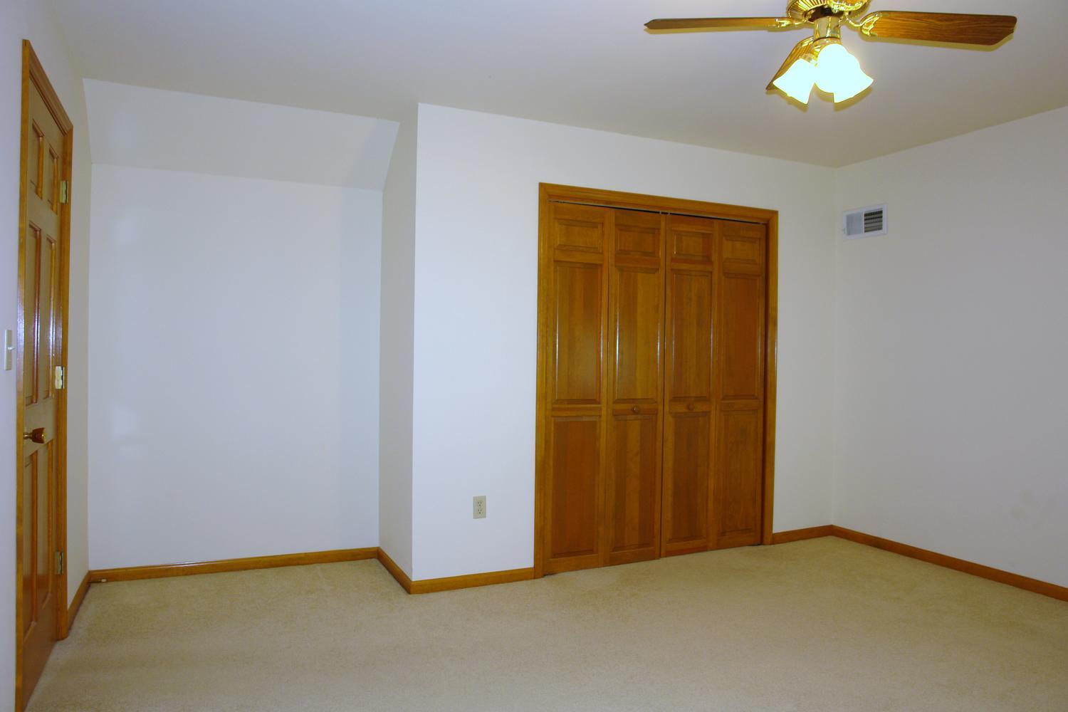 468 Liberty Road Penhook, VA 24137 - Photo 27 of 54 an empty room with windows and chandelier fan
