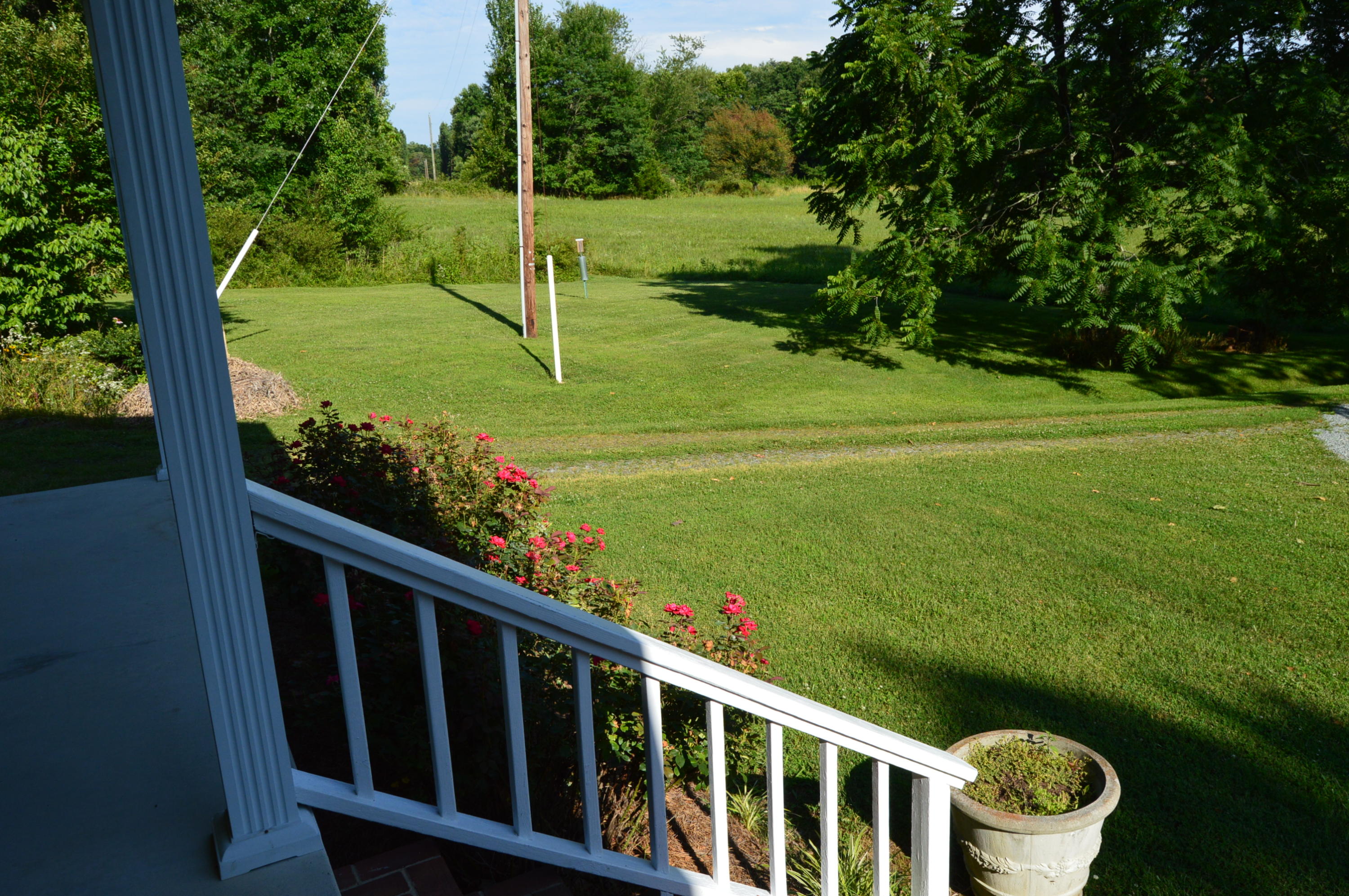 468 Liberty Road Penhook, VA 24137 - Photo 51 of 54 a view of a wooden deck with a big yard and potted plants