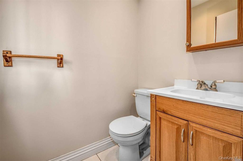 36 Bevin Road Northport, NY 11768 - Photo 11 of 26 Half bath with vanity and light tile patterned floors