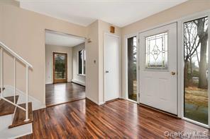 36 Bevin Road Northport, NY 11768 - Photo 2 of 26 Foyer entrance with stairs and dark wood-style flooring