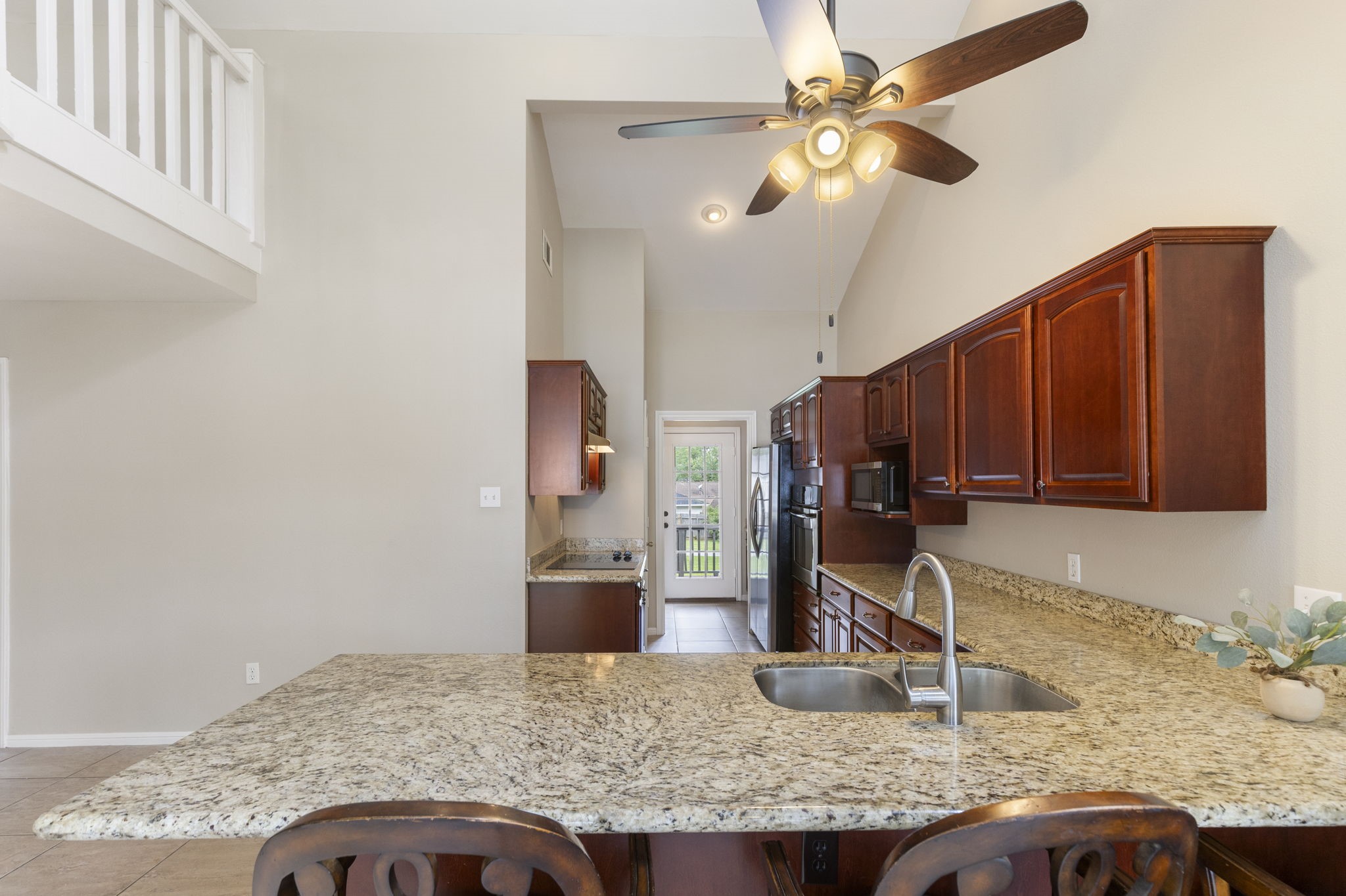 49 April Village Conroe, TX 77356 - Photo 10 of 46 a kitchen with granite countertop a sink a counter top space cabinets and stainless steel appliances