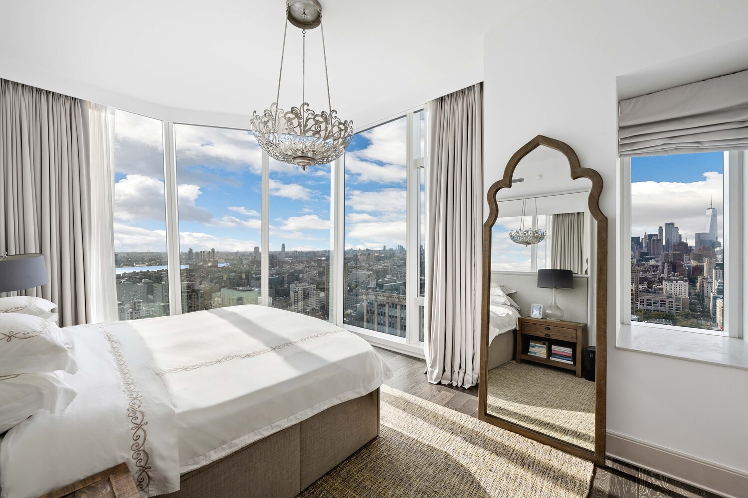 45 East 22nd Street, Unit 37B Manhattan, NY 10010 - Photo 10 of 13 a bedroom with a large bed and a chandelier
