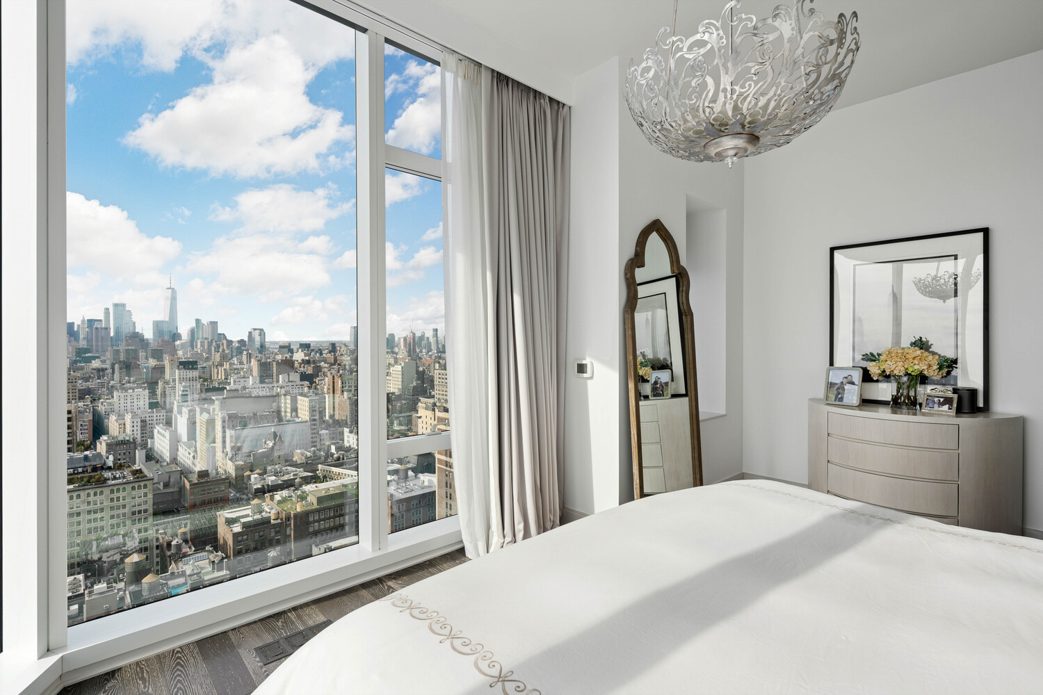 45 East 22nd Street, Unit 37B Manhattan, NY 10010 - Photo 12 of 13 a bedroom with a large bed and a chandelier